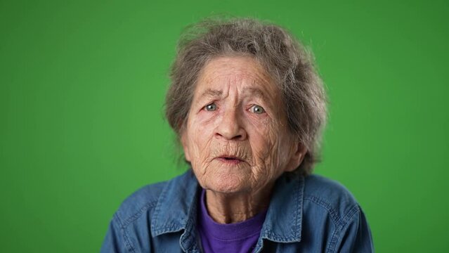 Tired depressed elderly mature toothless old woman 80s with migraine headache posing isolated on green screen background studio. Closeup people lifestyle concept. Put hands face