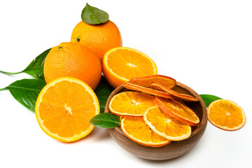 Dry orange slices and fresh fruits on white background. Dehydrated snacks of orange fruits. Healthy, no sugar sweet food. Candied citrus fruit