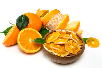 Naklejka na ściany i meble Dry orange slices and fresh fruits on white background. Dehydrated snacks of orange fruits. Healthy, no sugar sweet food. Candied citrus fruit
