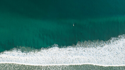 Waves with Surfers by the ocean in california coast manhattan beach