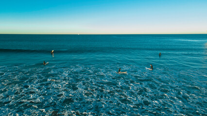 Waves with Surfers by the ocean in california coast manhattan beach