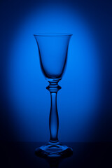 A glass for liqueur on a blue background