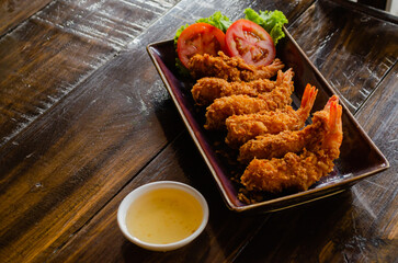 Traditional Thai food. Delicious shrimp in batter on a wooden table close-up