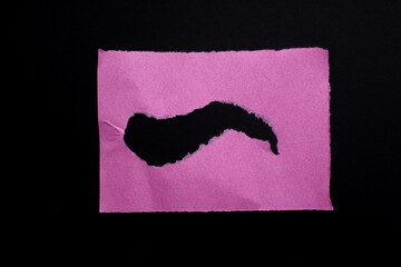 Pink torn paper texture background. Ripped paper on black background.