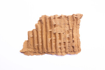 Ripped brown corrugated cardboard piece isolated on a white background