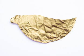 Ripped gold color paper piece isolated on a white background