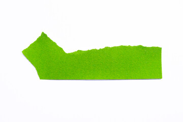Green ripped paper piece isolated on a white background