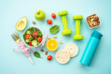 Diet food, healthy lifestyle and fitness background. Vegan salad, crispbread, fruits and dumbell....