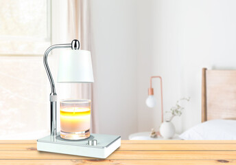 The luxury lighting aromatic scent glass candle is put on the electric lamp candle warmer heater on...