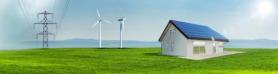 Windräder und Solarzellen auf einem Hausdach auf einer Grünen Wiese in einer hügeligen Landschaft