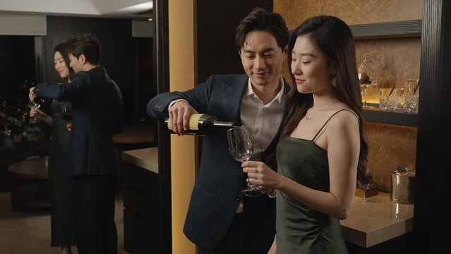 Elegant young couple enjoying red wine,4K