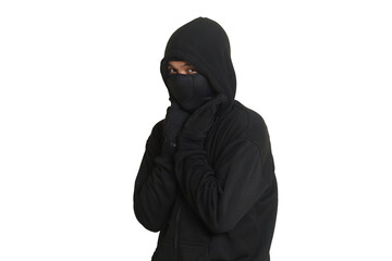 Mysterious man wearing black hoodie standing and looking at camera. Isolated image on gray...