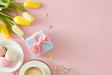 Fototapeta na wymiar Women's Day celebration concept. Top view photo of gift box cup of coffee macaroons small hearts bunch of yellow white tulips and gypsophila flowers on pastel pink background with copyspace