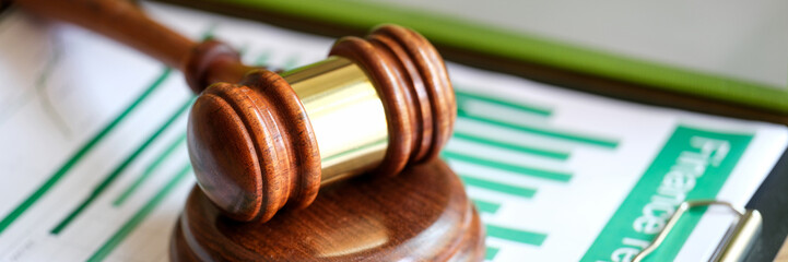Judge gavel on statistics documents with charts and graphs