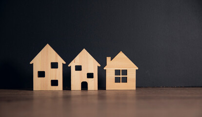 wooden house models on table.