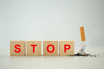 World No Tobacco Day Concept. Stop Smoking. A wooden block with the word stop written in red with...