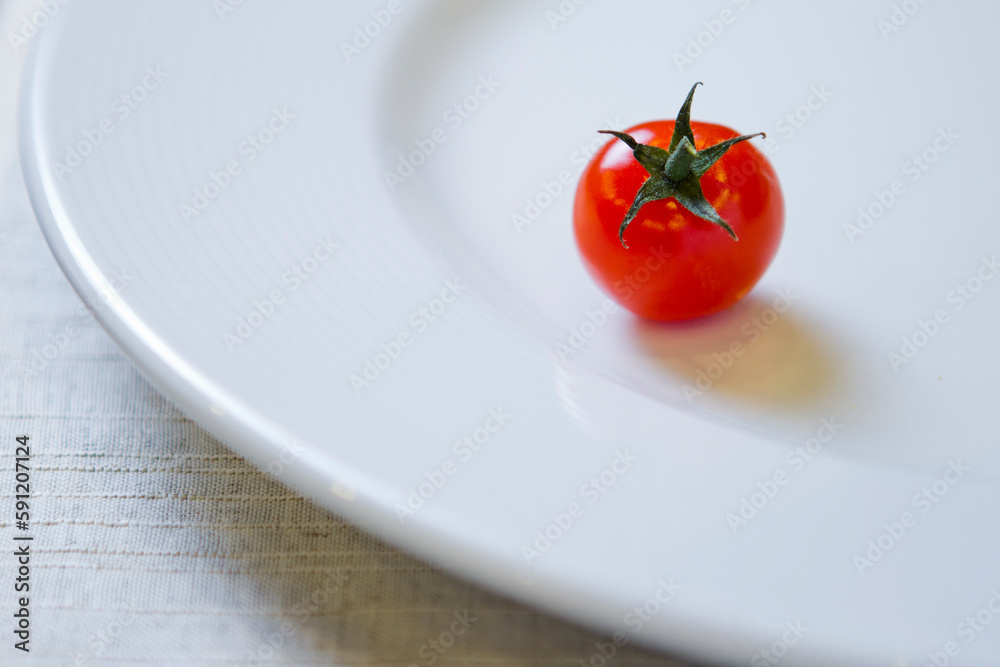 Wall mural cherry tomato on a white plate