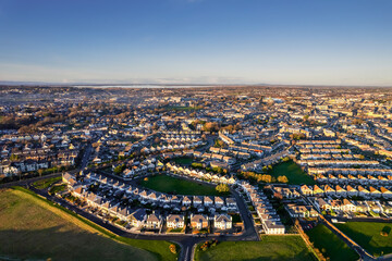 Aerial view on Salthill area of Galway city, Ireland. Warm sunny day. Popular educational center and tourist hub with vivid night life. High density residential area by the ocean.