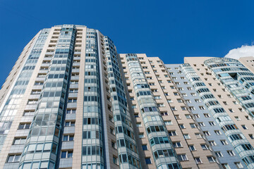 Fototapeta na wymiar Multi-storey apartment building with many windows