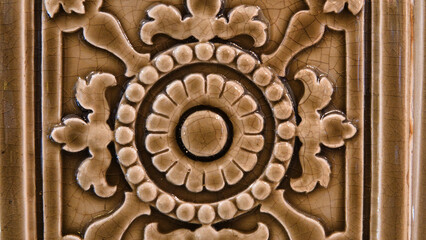 Traditional floral patterns carved on brown marble background, Ottoman marble carving