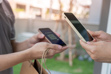 Happy smile Asian woman scan QR code for pay of food. Delivery man send deliver express. online shop, paper container, takeaway, postman, delivery service, packages, electronic money, Digital transfer