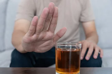  man refuses say no and avoid to drink an alcohol whiskey , stopping hand sign male, alcoholism treatment, alcohol addiction, quit booze, Stop Drinking Alcohol. Refuse Glass liquor, unhealthy, reject © Shisu_ka