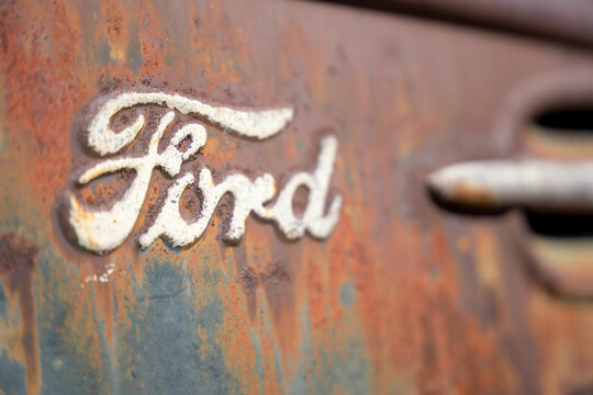 Las Vegas, Nevada, United States - 04-29-2021: Close up of a Ford Motor Company logo on a rusty metal vehicle door.