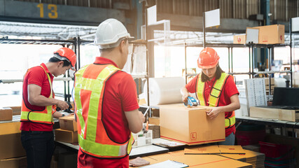 Warehouse worker checking details stock product and scanning a barcode on box package in the background warehouse., Industrial and industrial concept.