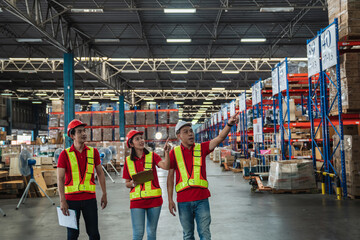 Obraz premium Warehouse workers walking to check details stock product in the background warehouse., Industrial and industrial concept..
