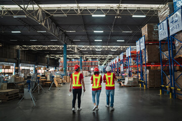 Warehouse workers walking to check details stock product in the background warehouse., Industrial...