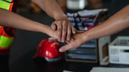 Group warehouse workers stack hand to celebrate and be happy in the warehouse., Industrial and industrial concept.