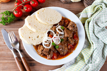 Fine Meat - Beef Goulash in a with Red Pepper on table. Top view