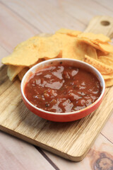 a bowl of chips and salsa on table ,