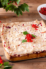 Appetizing homemade berry pie. Pie with red currants and sour cream on wooden table