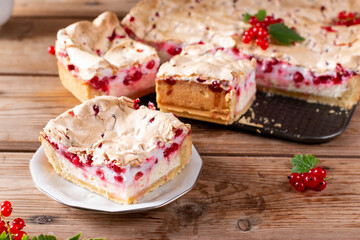Homemade cottage cheese casserole garnished with redcurrant on wooden table