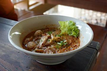 Tom Yum Noodles with Lime Pork, Great Taste, Sour, Sweet, Spicy, Lime Fragrance In a ceramic cup ready to serve. Soft and selective focus.