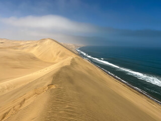 Sandwich Harbour in Namibia at the coast of the Atlantic Ocean. Sandy beach.