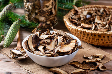 Arrangement of Forest Dried Mushrooms on Wooden table. Focus on Foreground