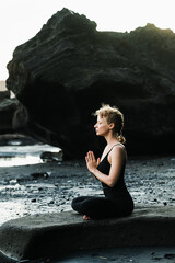 Young, beautiful girl - doing yoga and meditation on the beach.