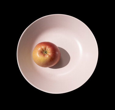 Apple in light brown plate nature morte
