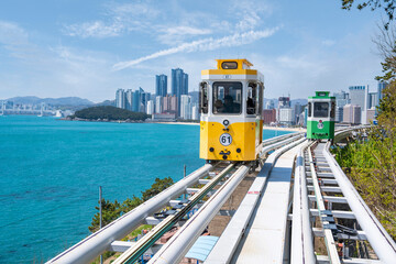  sky capsule train running on seaside railway tracks in Busan, Korea. It is a destination for...