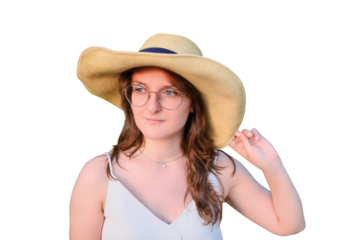 Woman with a straw hat on a background of spring nature, isolated on a white background. Woman in a white dress on a background of a blossoming tree