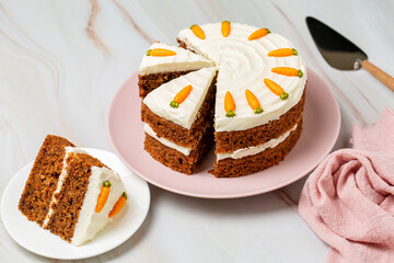 Carrot cake on the cake stand, made with carrots, walnuts, cinnamon, iced with cream cheese. Sweet...