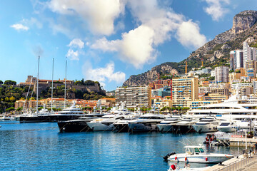Fototapeta na wymiar Monaco port, Monte Carlo. Coastal view with luxury yachts and boats. Panoramic view. Summer time, 2022.
