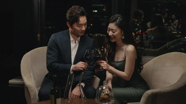 Elegant young couple enjoying red wine,4K