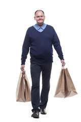 in full growth. casual mature man with shopping bags.