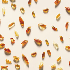Natural Amber texture background, yellow orange colored stones with shadow on beige. Natural gemstone mineral for jewelry. Transparent pieces gem Amber pattern, minimal top view nature card
