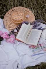 Still life of book and straw hat