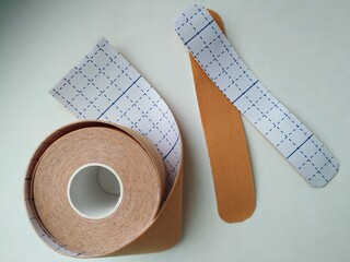 kinesiology tape on white background. Physiotherapy and therapeutic tape for wrist pain, aches and tension. elastic therapeutic tape. adhesive tape and alternative medicine

