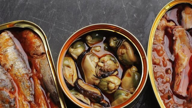 Spanish fish seafood Canned preserves food in tin open cans. sardines, squid, tuna, mussels in olive oil. Traditional Spanish supermarket food.